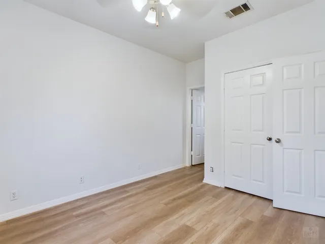 a view of an empty room and wooden floor