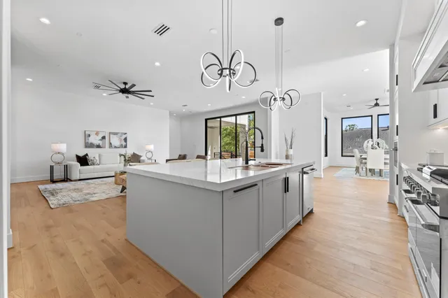 a kitchen with white cabinets and counter space