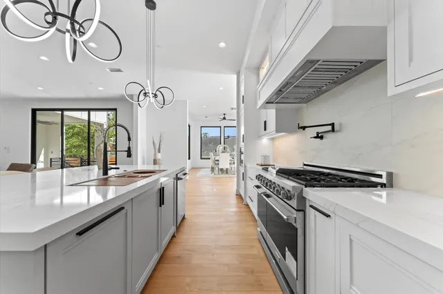 a spacious bedroom with a large bed and a chandelier