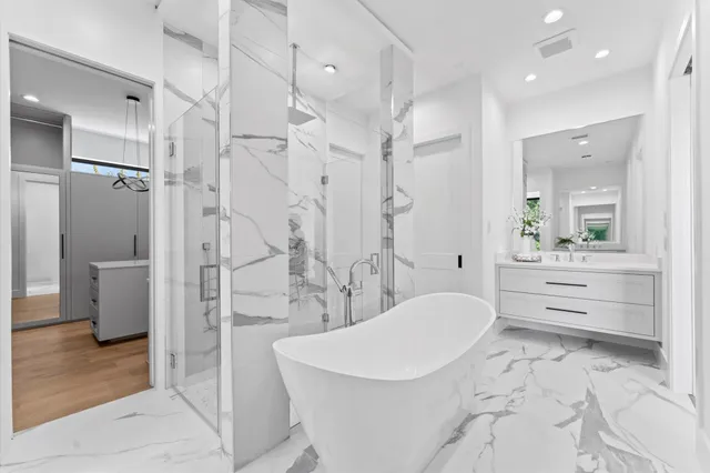 a kitchen with a sink a stove a refrigerator and white cabinets