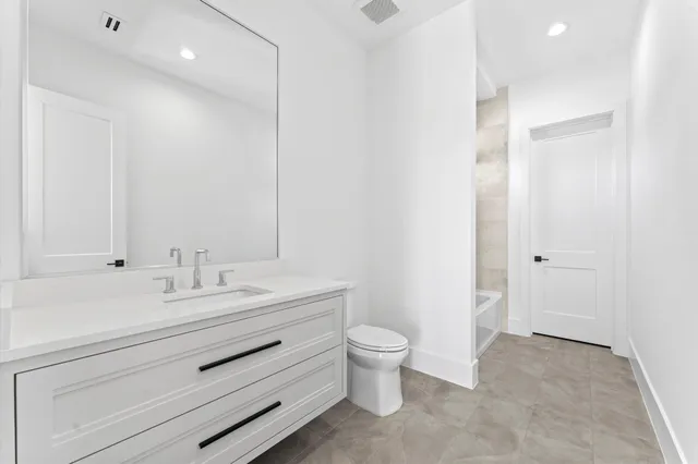 a bathroom with a shower sink vanity and mirror