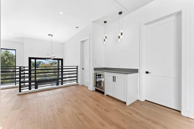 a view of a room with wooden floor
