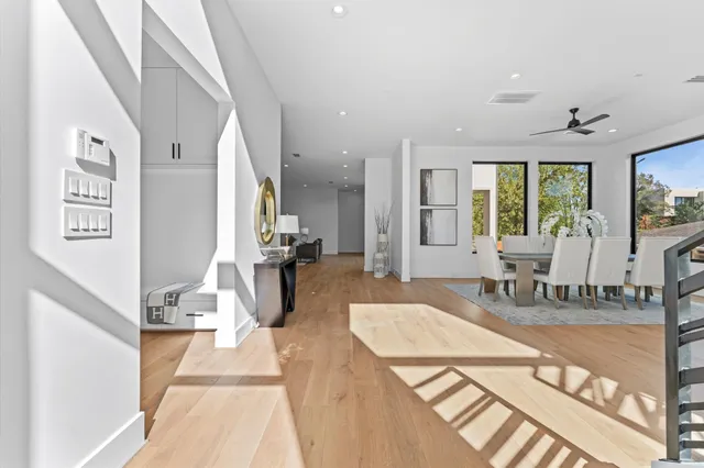 a dining room with furniture window and wooden floor