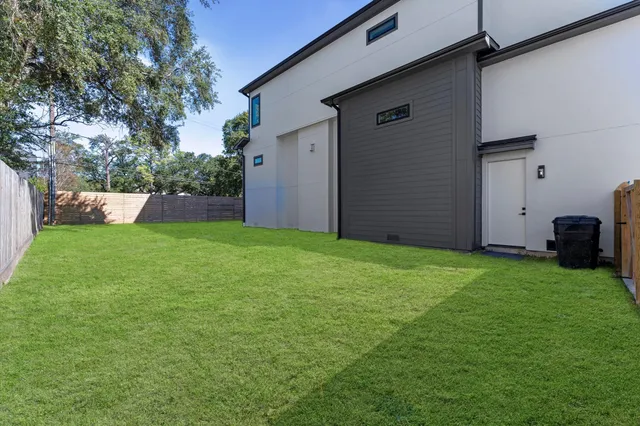 an aerial view of house with yard and swimming pool
