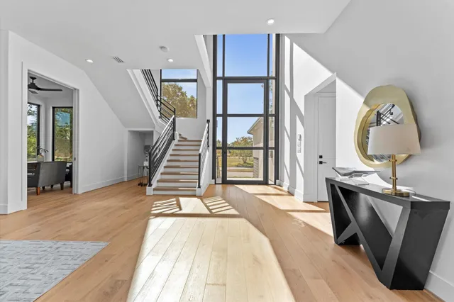 a living room with fireplace furniture and a large window