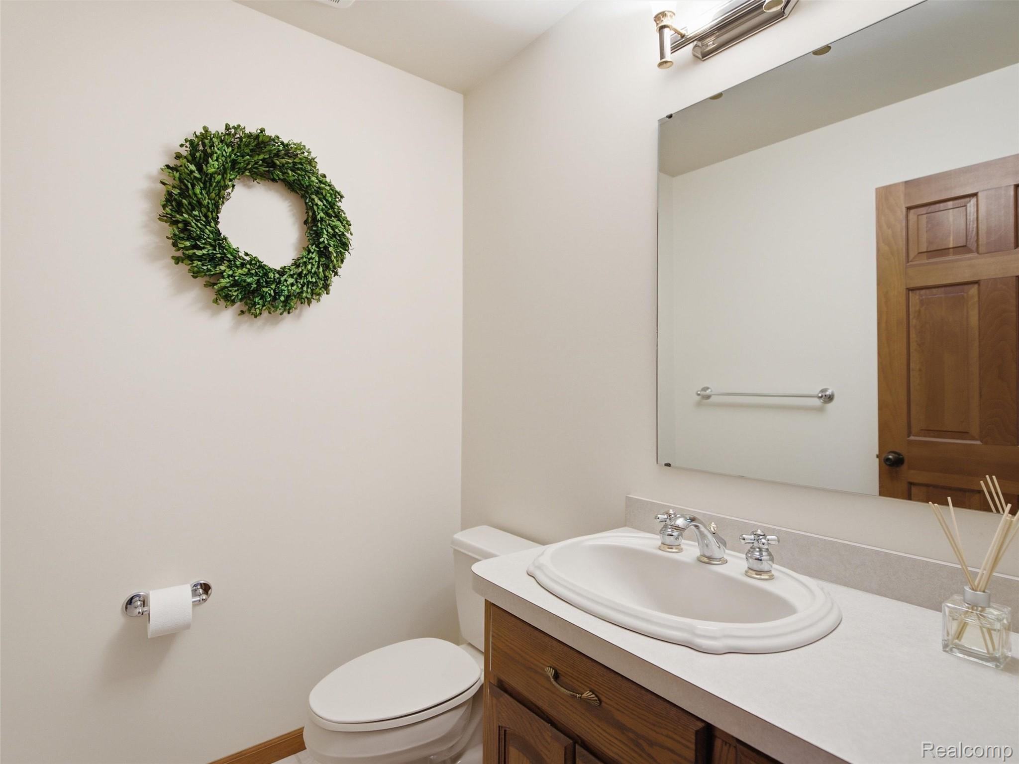 5449 Lum Road Attica, MI 48412 - Photo 42 of 82 Vanity featuring an oval drop-in sink, chrome faucet, and light-toned countertop