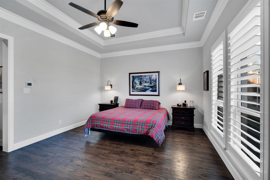 2501 Running Ranch Place Arlington, TX 76001 - Photo 18 of 38 a bedroom with a bed and a chandelier