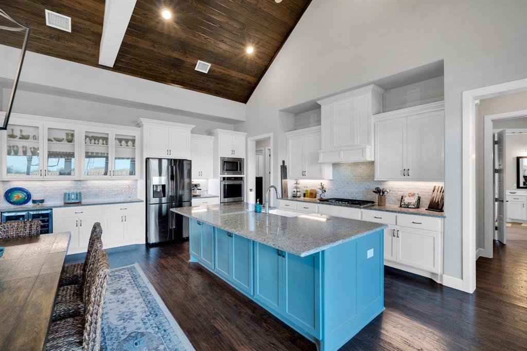 2501 Running Ranch Place Arlington, TX 76001 - Photo 5 of 38 a large kitchen with stainless steel appliances lots of counter space and wooden floors