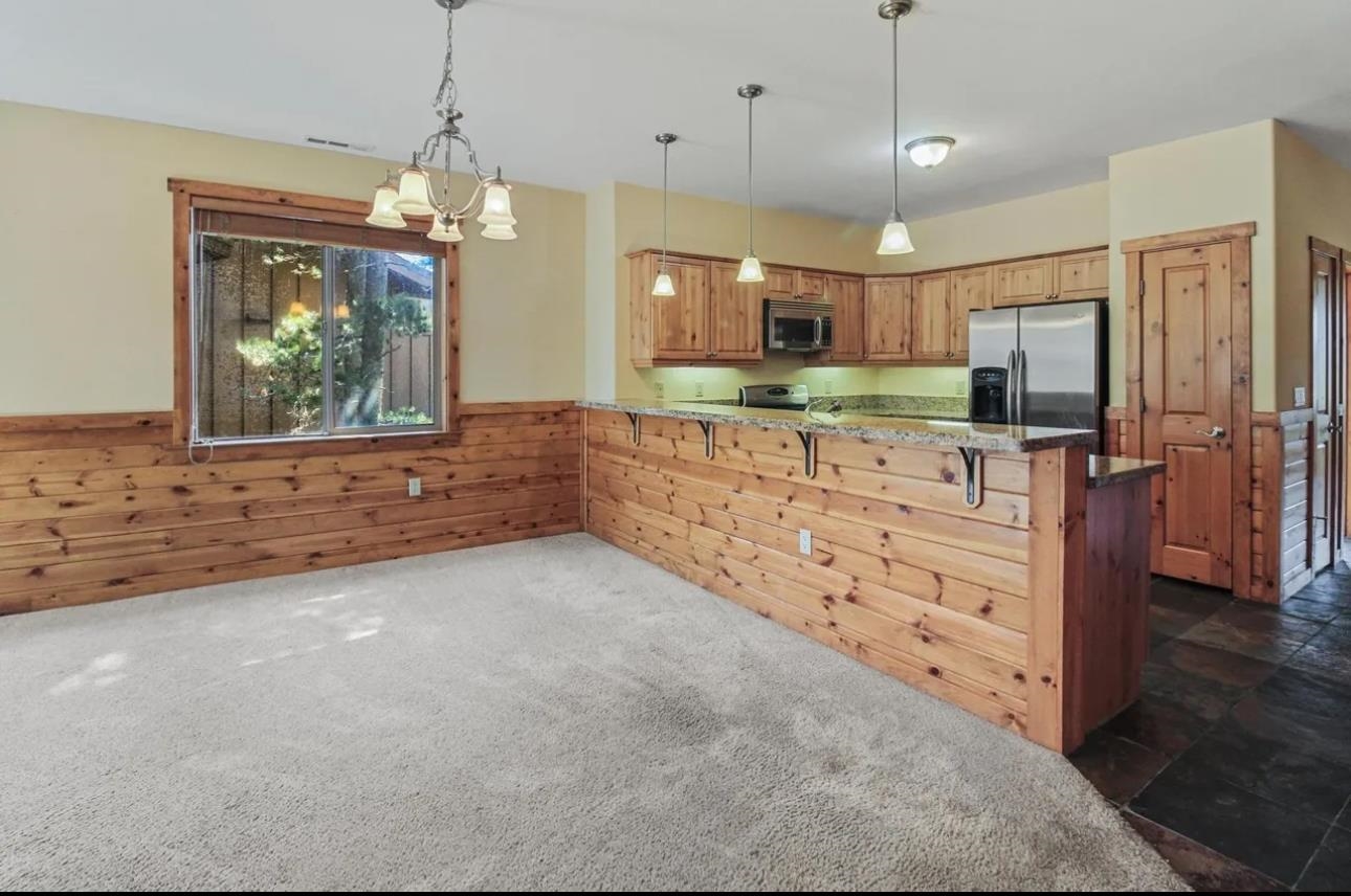 11612 Dolomite Way, Unit 4 Truckee, CA 96161 - Photo 3 of 16 a large kitchen with kitchen island a large counter top space a sink stainless steel appliances and cabinets