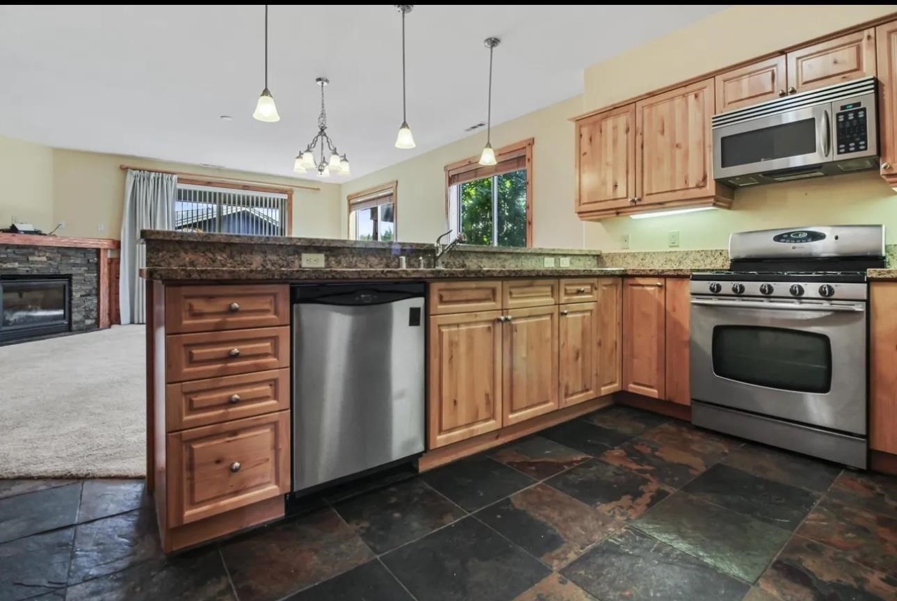 11612 Dolomite Way, Unit 4 Truckee, CA 96161 - Photo 4 of 16 a kitchen with stainless steel appliances granite countertop a stove and a microwave
