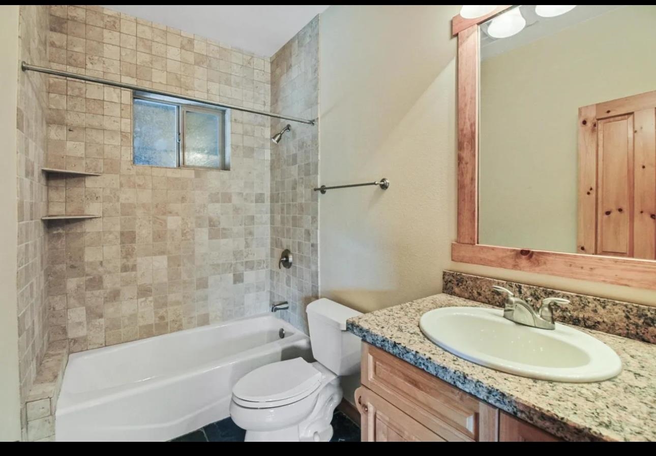 11612 Dolomite Way, Unit 4 Truckee, CA 96161 - Photo 7 of 16 a bathroom with a granite countertop sink toilet mirror and bathtub