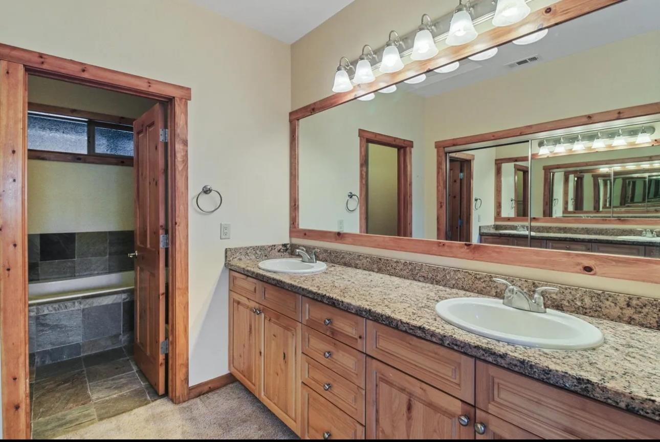 11612 Dolomite Way, Unit 4 Truckee, CA 96161 - Photo 10 of 16 a bathroom with a granite countertop sink and a mirror