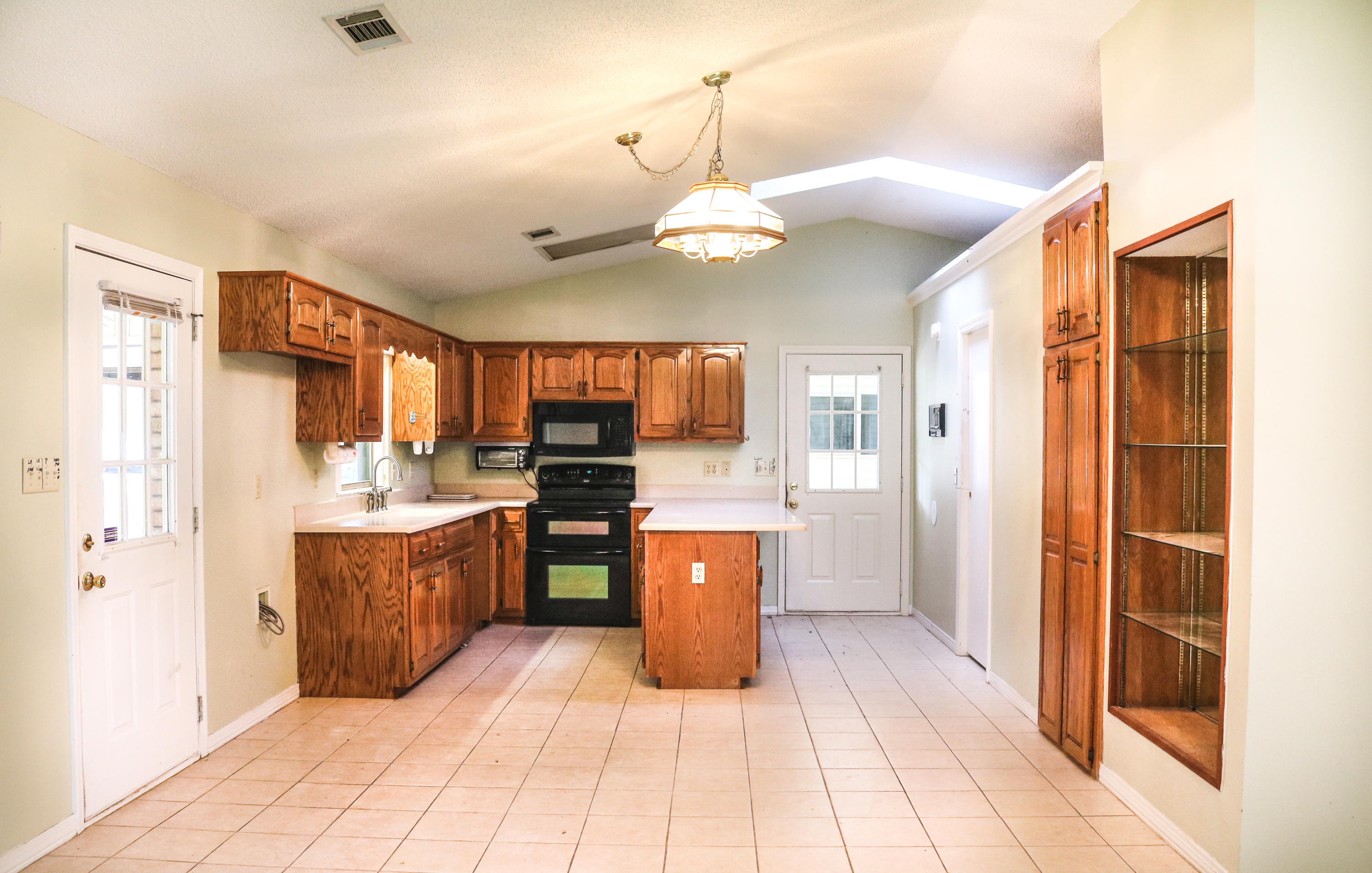 6123 Buckward Road Baker, FL 32531 - Photo 8 of 28 a large kitchen with stainless steel appliances granite countertop a refrigerator and a sink