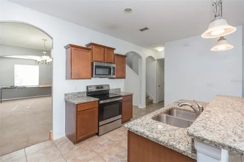 a view of a kitchen with granite countertop cabinets and a sink