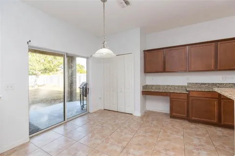 a view of a kitchen with kitchen island stainless steel appliances a sink cabinets and a counter top space