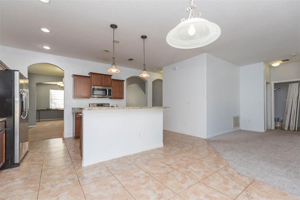 1803 Palm Warbler Lane Ruskin, FL 33570 - Photo 15 of 51 a view of a kitchen with kitchen island stainless steel appliances a sink cabinets and a counter top space