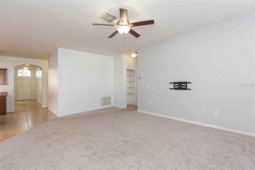 1803 Palm Warbler Lane Ruskin, FL 33570 - Photo 19 of 51 an empty room with closet and a chandelier fan