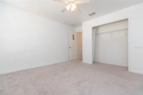 a bathroom with a granite countertop sink a large mirror and a window