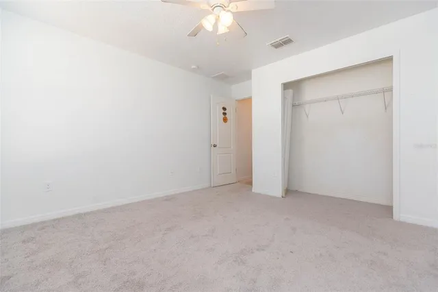 a bathroom with a granite countertop sink a large mirror and a window