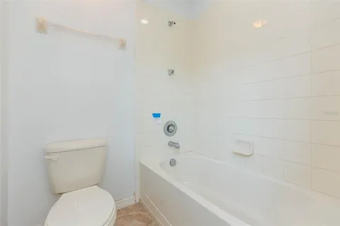 a bathroom with a toilet and a bathtub