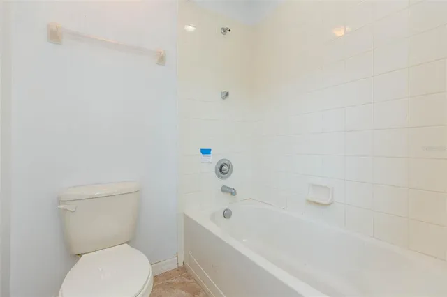 a bathroom with a toilet and a bathtub