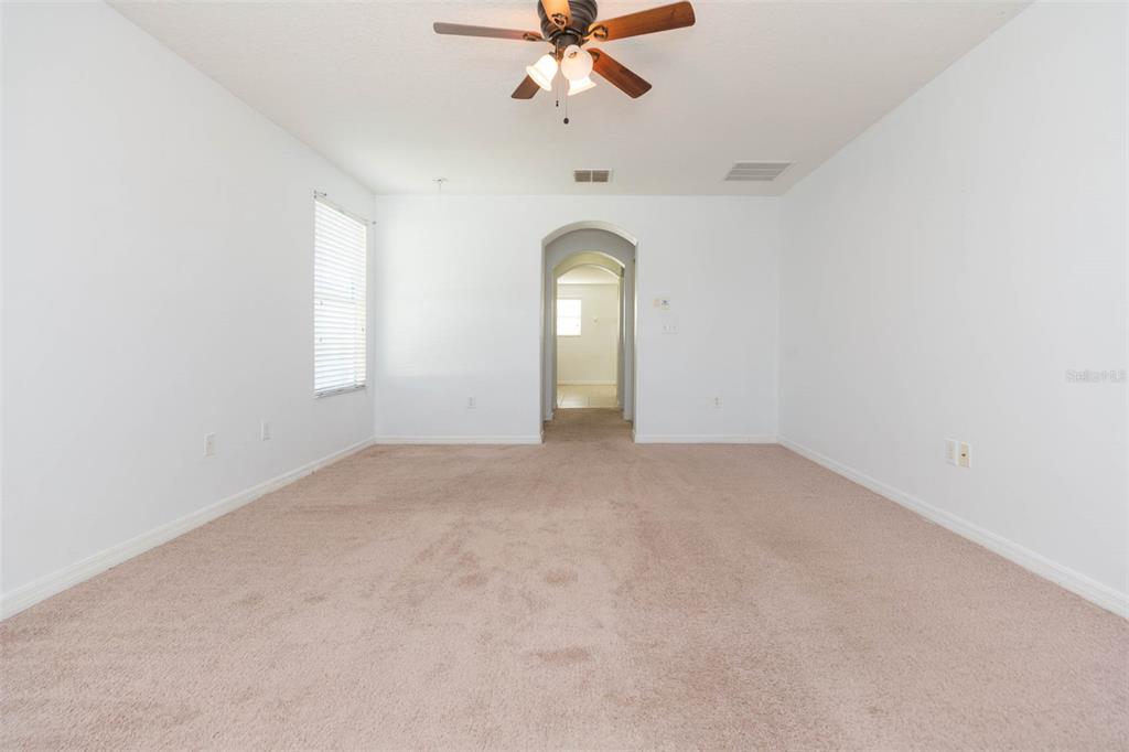 1803 Palm Warbler Lane Ruskin, FL 33570 - Photo 41 of 51 an empty room with a window and a chandelier fan