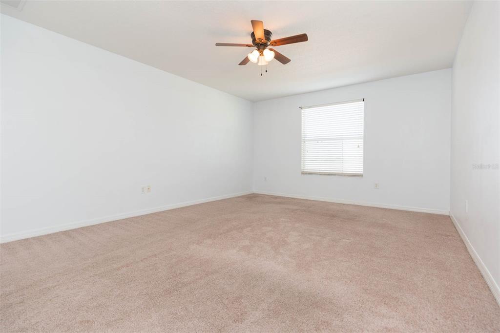 1803 Palm Warbler Lane Ruskin, FL 33570 - Photo 43 of 51 an empty room with a window and a ceiling fan