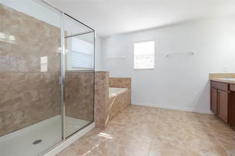 a bathroom with a bathtub and a shower