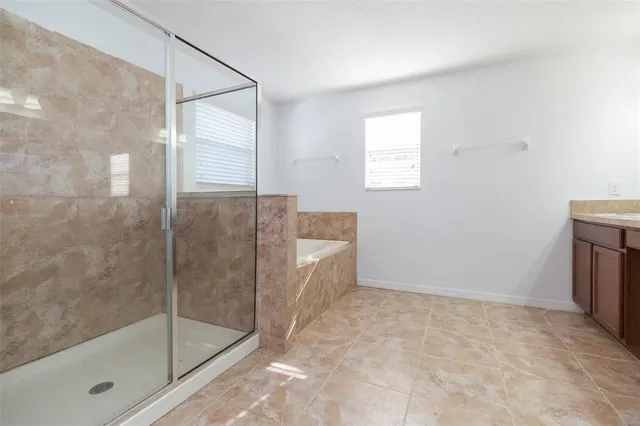 a bathroom with a bathtub and a shower