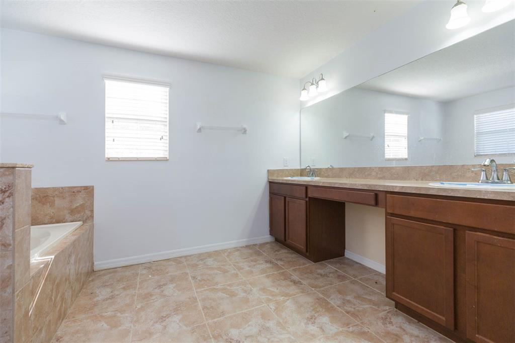 1803 Palm Warbler Lane Ruskin, FL 33570 - Photo 46 of 51 a bathroom with a granite countertop sink and mirror