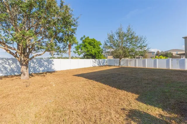 a view of a house with a yard and garage