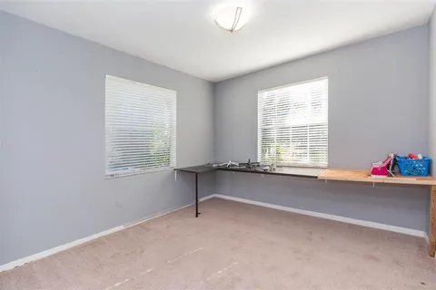 en view of a hallway with chandelier and glass door