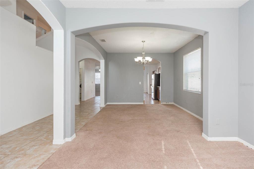 1803 Palm Warbler Lane Ruskin, FL 33570 - Photo 6 of 51 en view of a hallway with chandelier and glass door