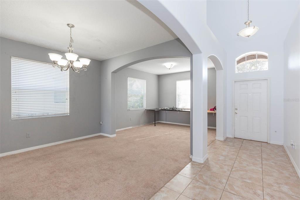 1803 Palm Warbler Lane Ruskin, FL 33570 - Photo 10 of 51 a view of a hallway with windows and chandelier