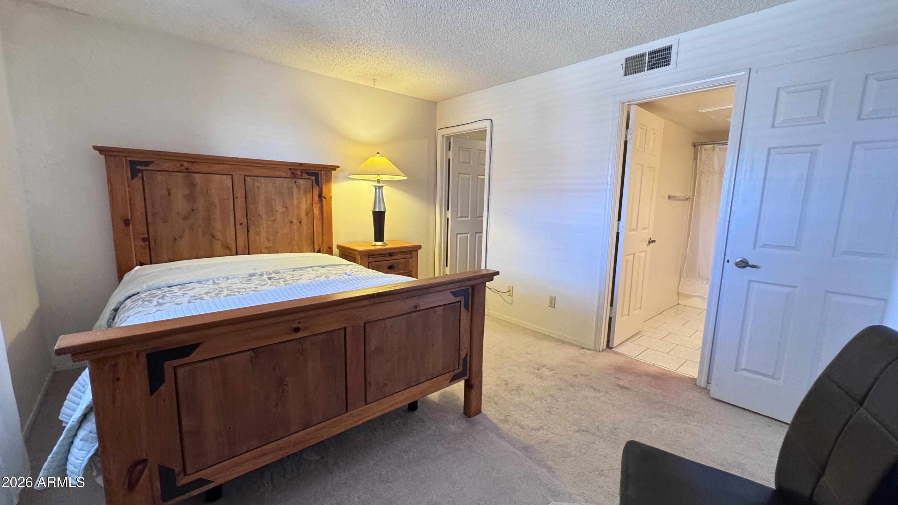 1440 North Idaho Road, Unit 1016 Apache Junction, AZ 85119 - Photo 10 of 22 a bedroom with a sink and a mirror