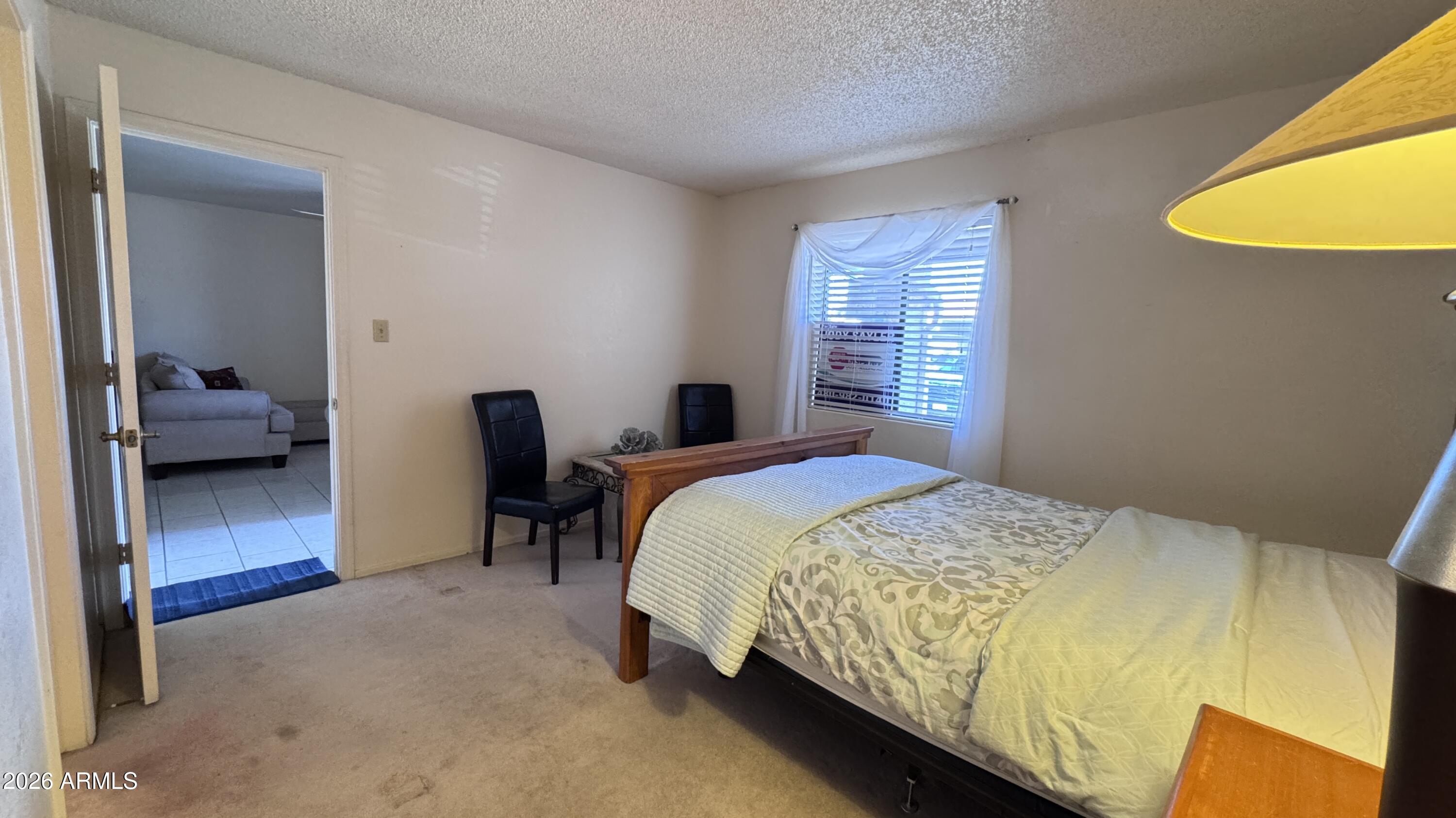 1440 North Idaho Road, Unit 1016 Apache Junction, AZ 85119 - Photo 12 of 22 a bed sitting in a bedroom next to a window