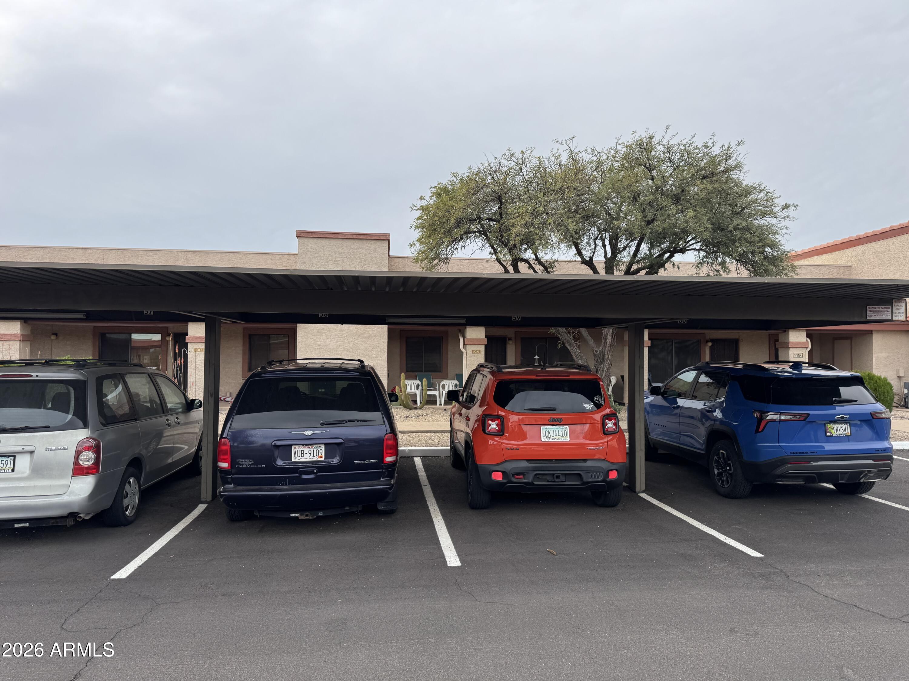 1440 North Idaho Road, Unit 1016 Apache Junction, AZ 85119 - Photo 15 of 22 a view of cars parked in a parking