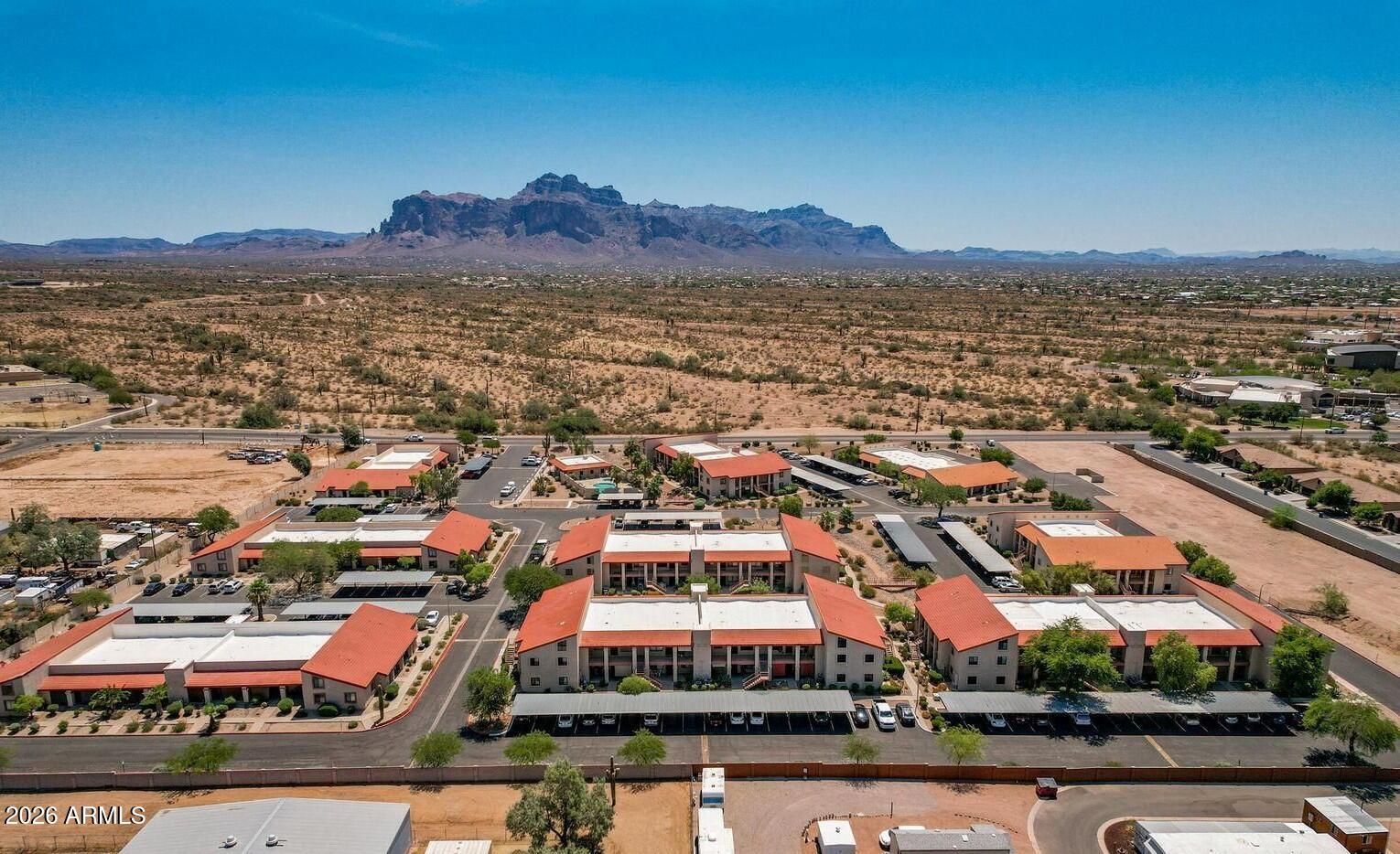 1440 North Idaho Road, Unit 1016 Apache Junction, AZ 85119 - Photo 17 of 22 an aerial view of residential houses with outdoor space