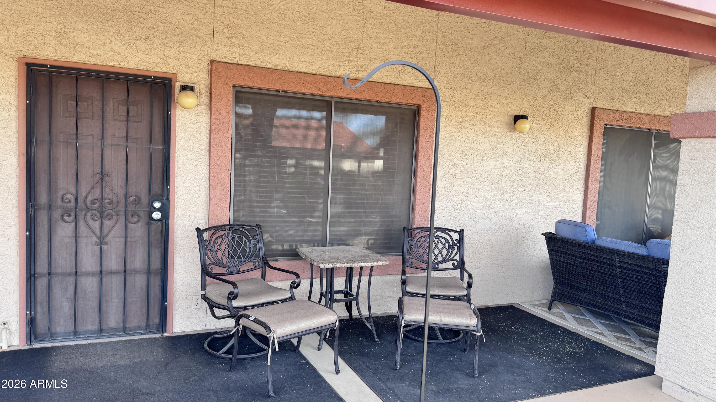 1440 North Idaho Road, Unit 1016 Apache Junction, AZ 85119 - Photo 3 of 22 a outdoor living space with furniture and a window