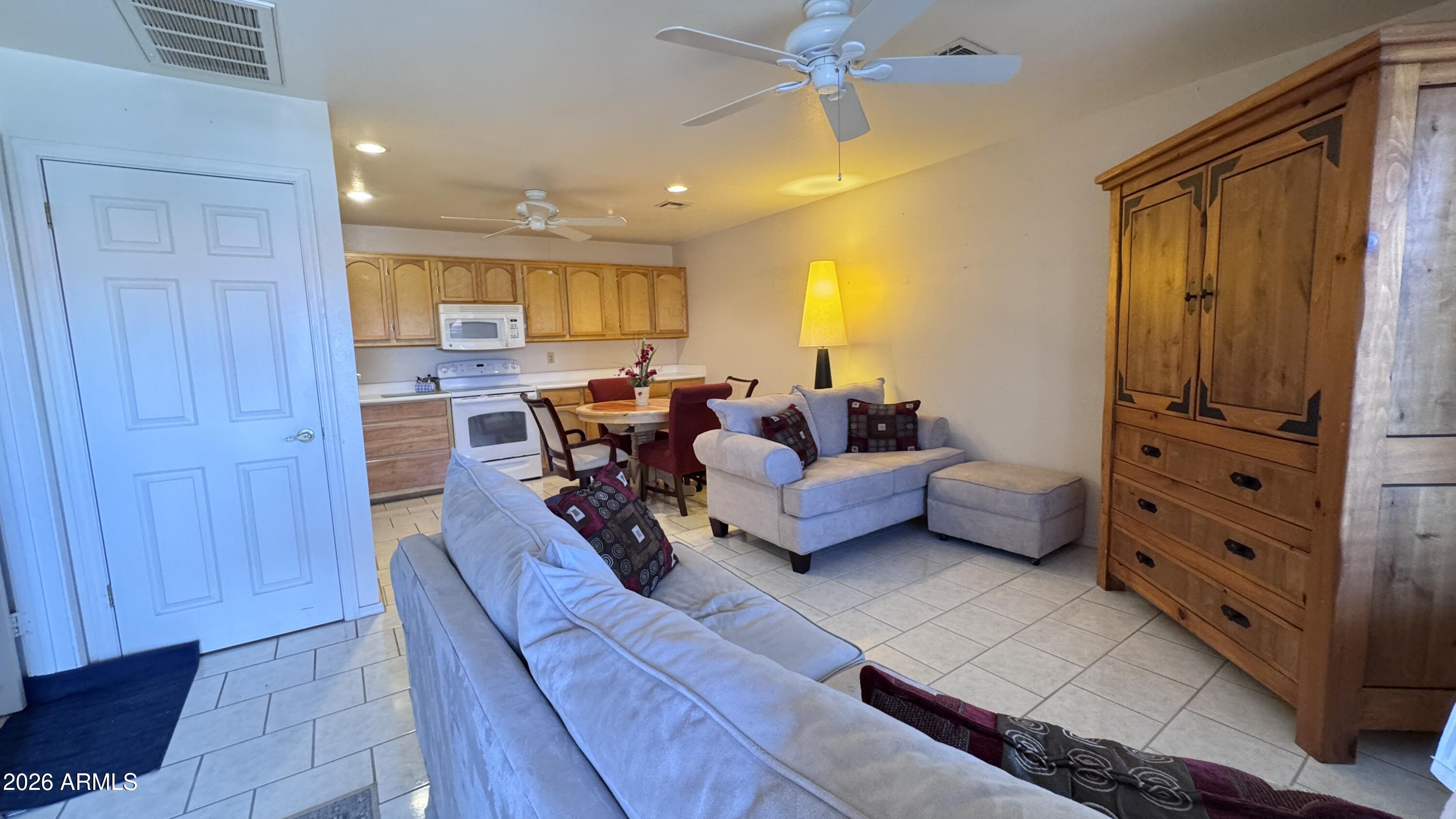 1440 North Idaho Road, Unit 1016 Apache Junction, AZ 85119 - Photo 4 of 22 a living room with furniture and a flat screen tv