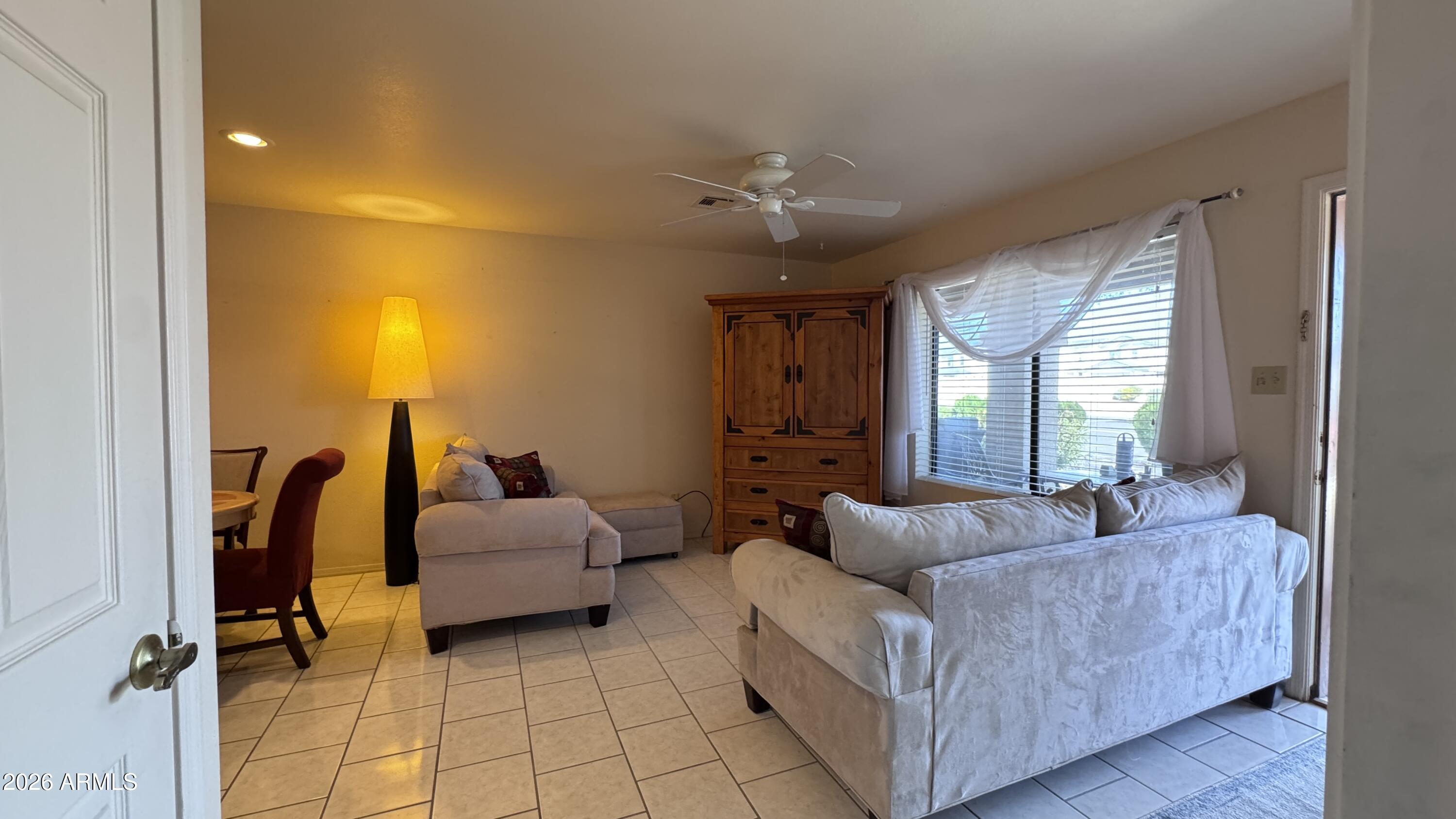 1440 North Idaho Road, Unit 1016 Apache Junction, AZ 85119 - Photo 5 of 22 a living room with furniture and a chandelier