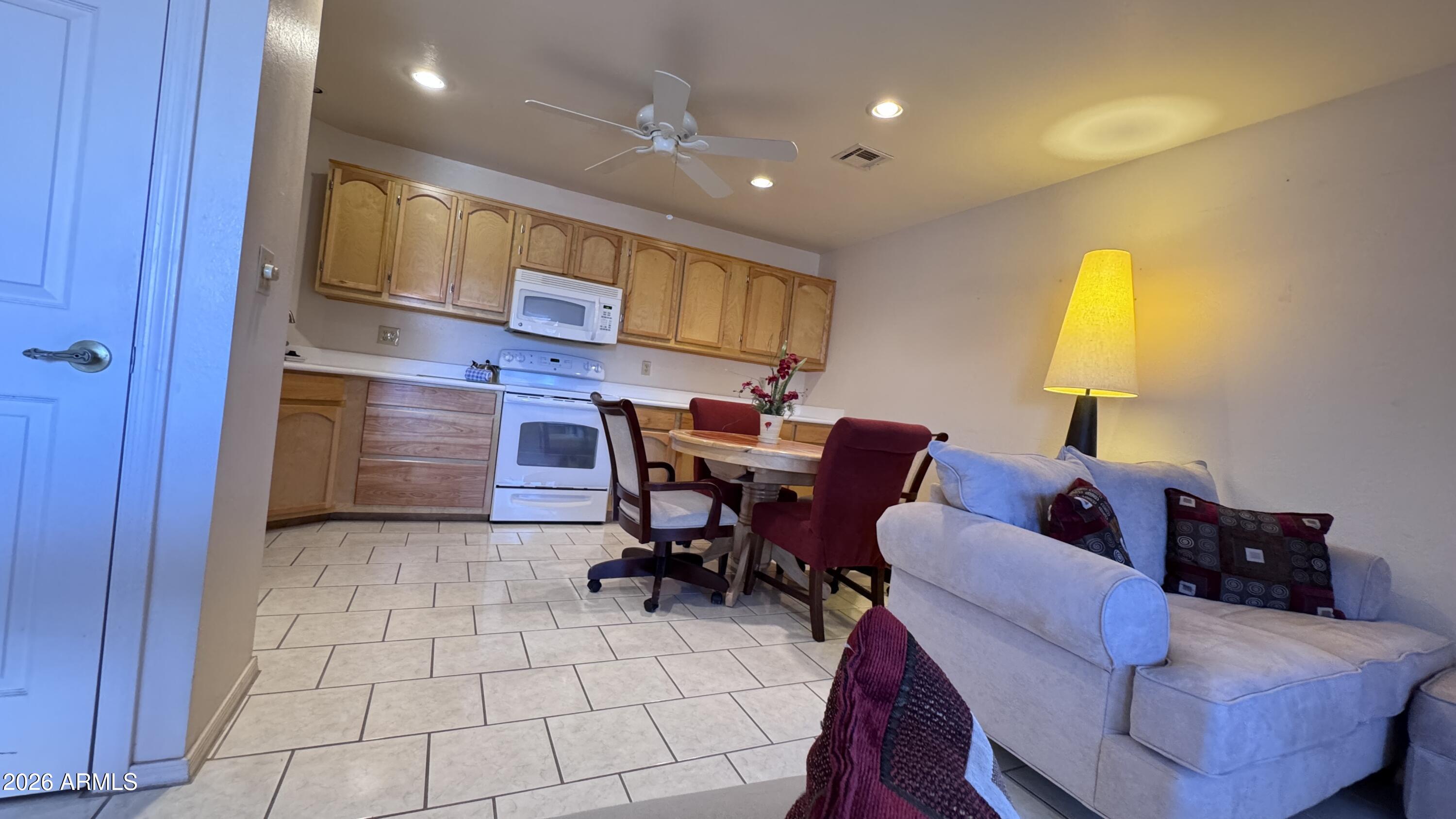 1440 North Idaho Road, Unit 1016 Apache Junction, AZ 85119 - Photo 22 of 22 a living room with furniture a lamp and a window