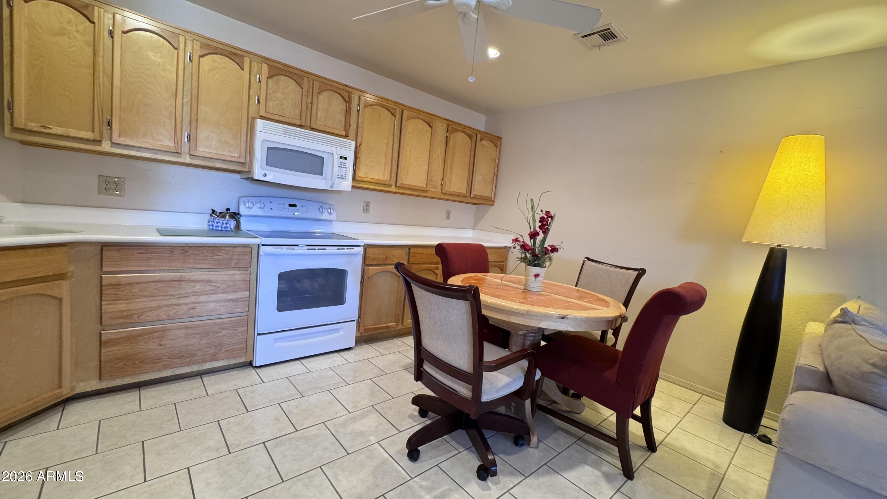 1440 North Idaho Road, Unit 1016 Apache Junction, AZ 85119 - Photo 7 of 22 a dining room with furniture and window