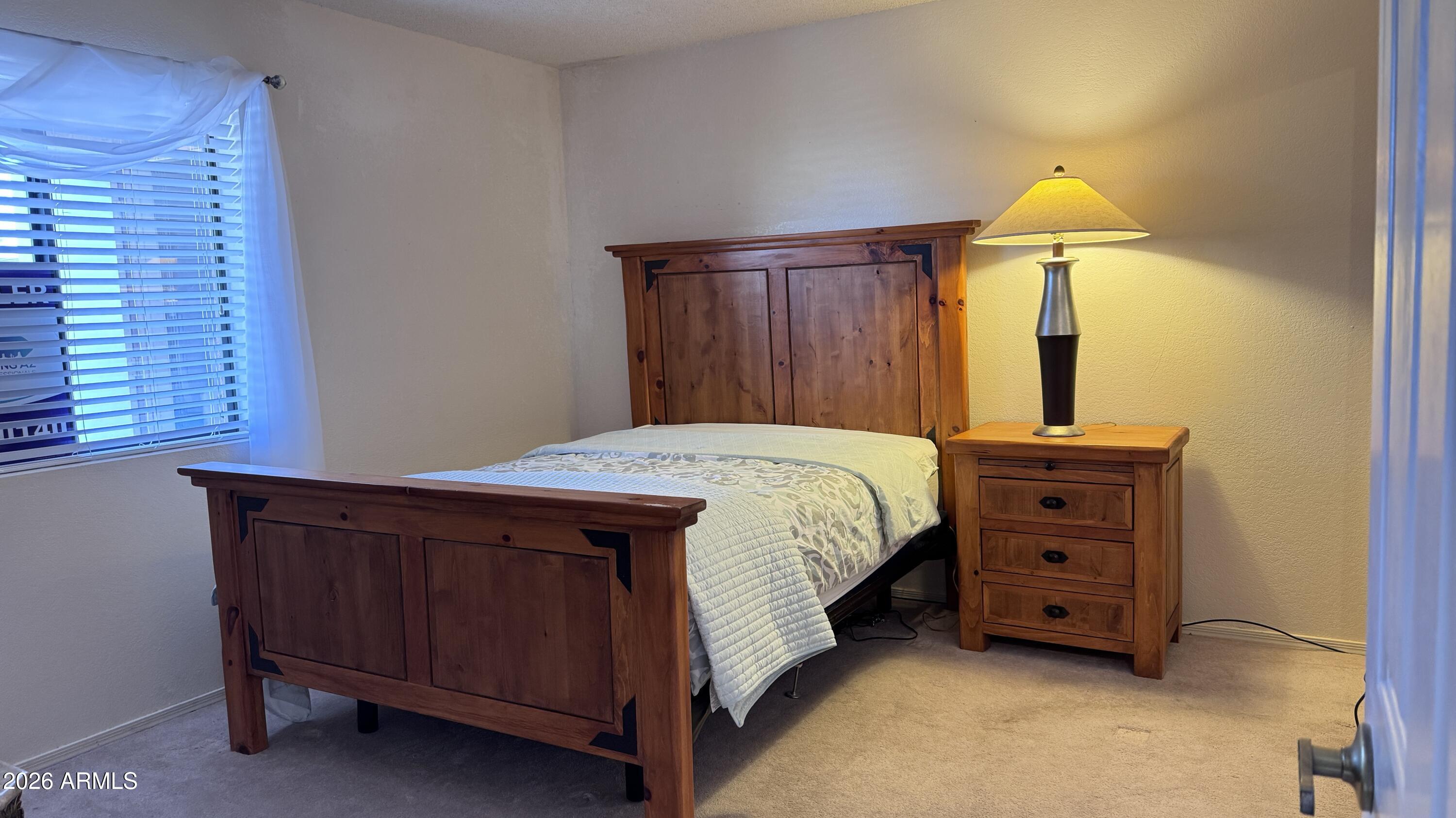 1440 North Idaho Road, Unit 1016 Apache Junction, AZ 85119 - Photo 9 of 22 a bedroom with a bed and a dresser