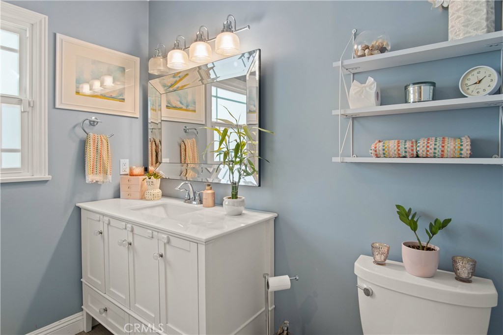 6835 Aldea Avenue Van Nuys, CA 91406 - Photo 12 of 50 a view of bathroom with a sink a toilet and a window