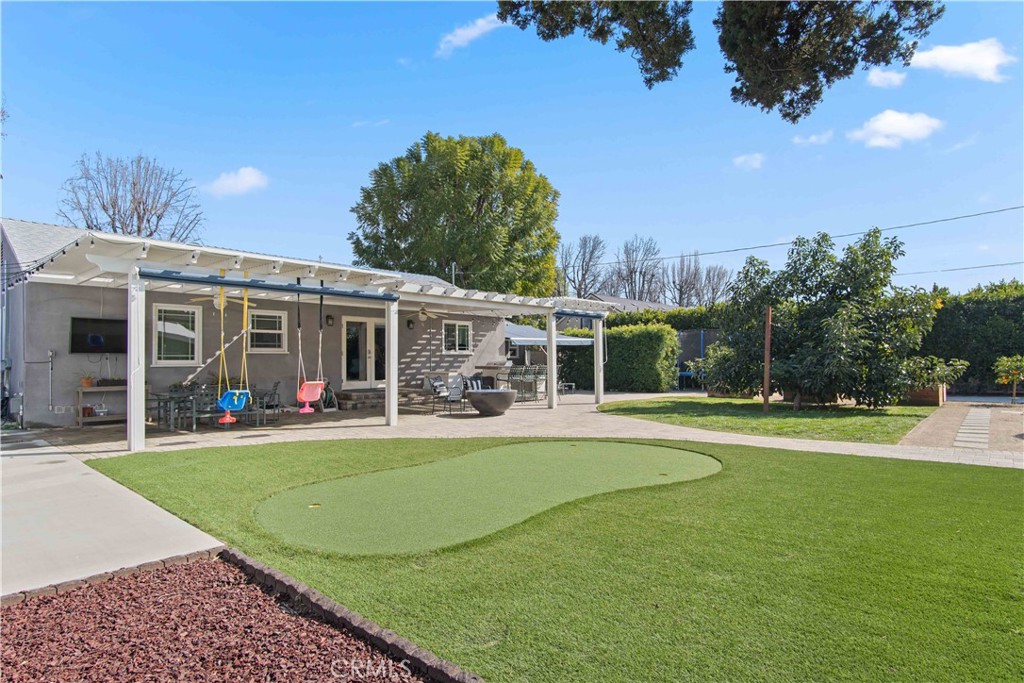 6835 Aldea Avenue Van Nuys, CA 91406 - Photo 21 of 50 a view of a house with swimming pool and a yard