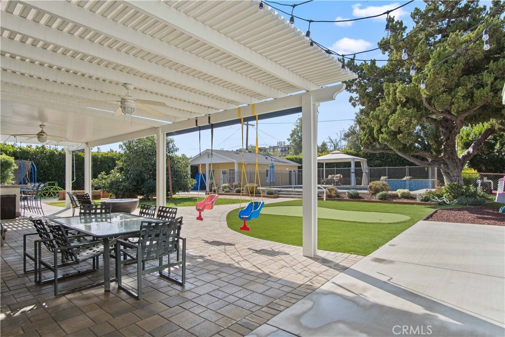 6835 Aldea Avenue Van Nuys, CA 91406 - Photo 26 of 50 a view of a patio with a table and chairs under an umbrella