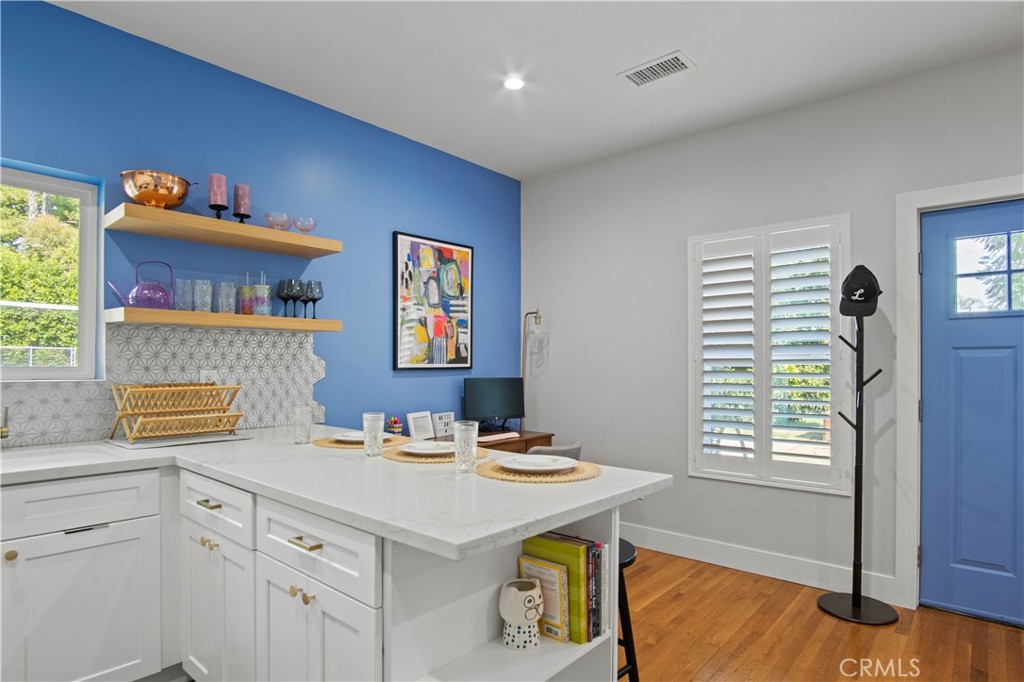6835 Aldea Avenue Van Nuys, CA 91406 - Photo 36 of 50 a kitchen with a sink cabinets and a table