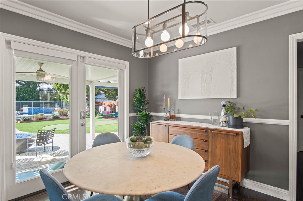 6835 Aldea Avenue Van Nuys, CA 91406 - Photo 4 of 50 a dining room with furniture a chandelier and window