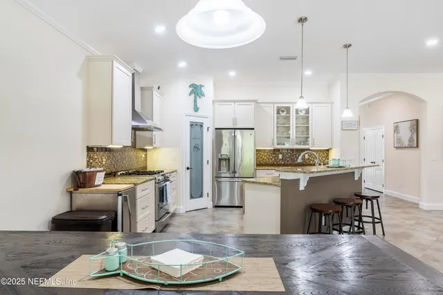 a spacious bedroom with a bed and a flat screen tv